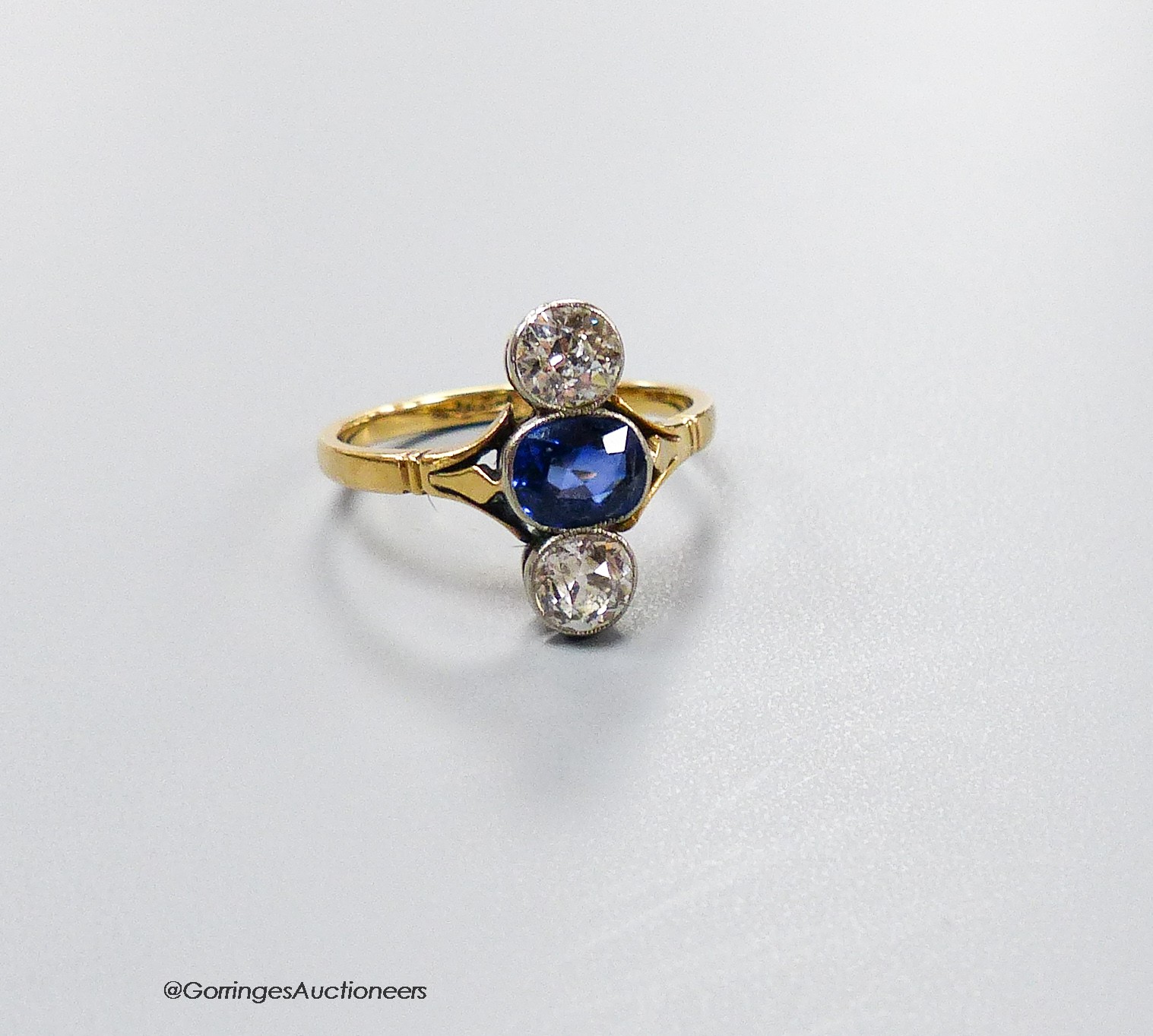 A, 18ct, two stone diamond and single stone sapphire set upfinger ring, size M, gross 2.9 grams